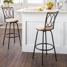 two barstools sitting in front of a kitchen island