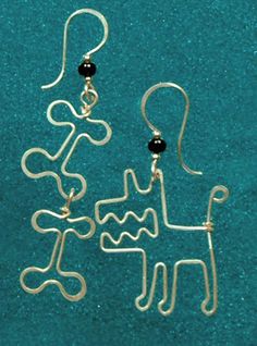 a pair of earrings that have been made to look like a dog