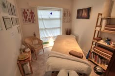 a room with a bed, chair and shelves in it