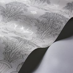 a close up view of a wallpaper with flowers and plants on it, in black and white