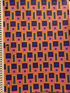 a notebook with a colorful quilt on it