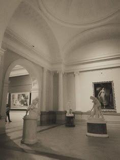 black and white photograph of statues in an art gallery