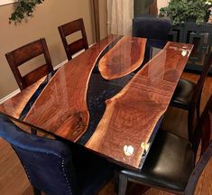 a wooden table with black leather chairs around it