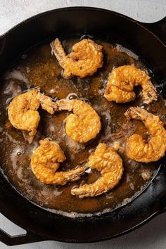 some fried shrimp in a skillet on a table