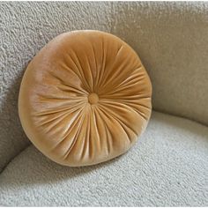 a round cushion on the back of a couch