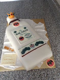 a birthday cake made to look like a bottle of bacardi with a crown on top