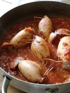 some meat and potatoes are cooking in a pot