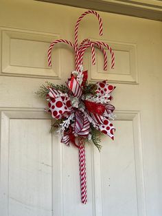 a candy cane wreath hanging on the front door