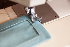 the sewing machine is working on the piece of fabric that's being sewn