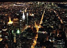 an aerial view of the city lights at night from top of skyscrapers in new york city