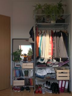 the closet is full of clothes, shoes and other things to put on it's shelves