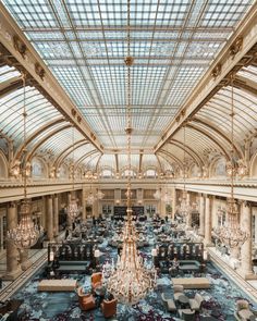 an ornately decorated lobby with chandeliers and couches in the center is shown