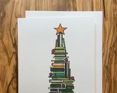 a card with a christmas tree made out of books