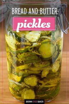 a jar filled with pickles sitting on top of a wooden table