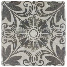 a square tile with an ornate design on the front and back side, in grey tones