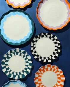 six plates with different designs on them sitting next to each other