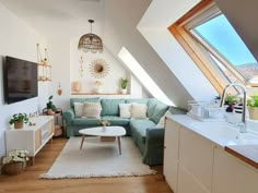 a living room filled with furniture and a flat screen tv on top of a wooden floor