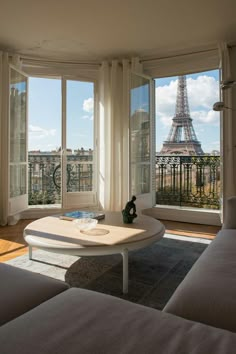 a living room with large windows overlooking the eiffel tower