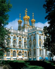 the building is blue and white with gold domes