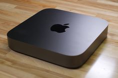 an apple computer sitting on top of a wooden table