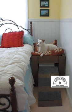 a white dog laying on top of a bed next to a wooden headboard and foot board