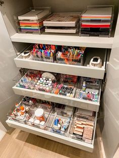 an organized closet with lots of crafting supplies on the shelves and drawers in it