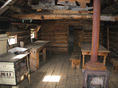 an old fashioned kitchen with wooden floors and walls