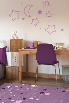 a purple chair sitting in front of a desk