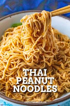 a bowl full of noodles and chopsticks with the words thai peanut noodles above it