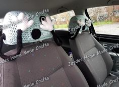 the interior of a car with stuffed animals on it's head and seat covers