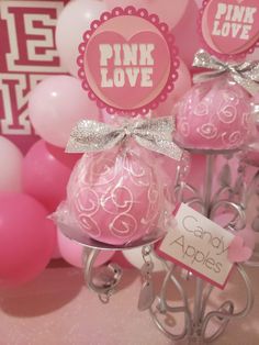 pink and white balloons are on display at a party