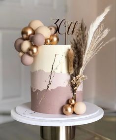 a pink and white cake with gold decorations