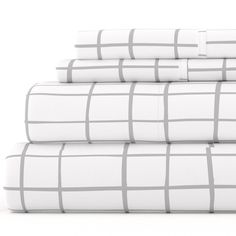 four white sheets stacked on top of each other in front of a white background with gray squares