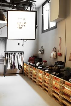 the inside of a clothing store with clothes on display