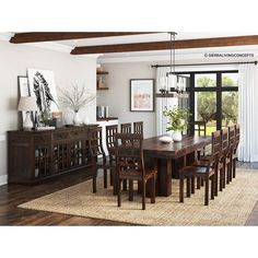 a dining room table and chairs in front of a sliding glass door