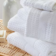 a stack of white towels sitting on top of a table