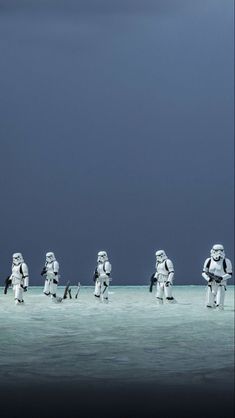 several stormtroopers are standing in the water