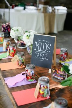 the table is set up with candy jars and place cards for guests to write their names