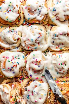 a tray filled with donuts covered in frosting and sprinkles