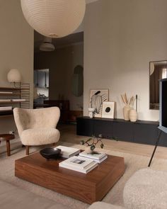 a living room filled with furniture and a flat screen tv on top of a wooden table