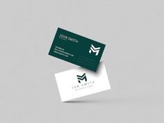 two business cards on top of each other with the letter m in green and white