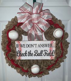 a wreath with baseballs on it that says, if we don't answer check the ball field