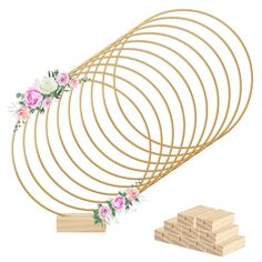 a bunch of wooden sticks with flowers on them and some wood blocks next to it