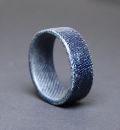 a close up of a blue ring on a gray surface with no one around it