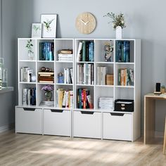 a white bookcase filled with lots of books