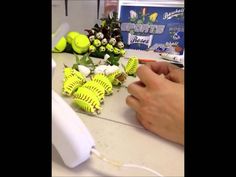 a person is cutting up some baseballs on a table