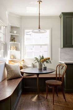 a kitchen table with two chairs next to it