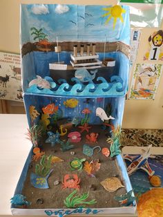 an ocean scene made out of cardboard with sea animals on the bottom and under it