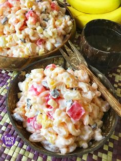 two bowls filled with macaroni salad next to bananas