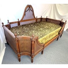 Fabulous antique French cane daybed!  This lovely piece is made of double cane in a medium wood tone with a carved wood frame including carved roses and ribbon swags on the top, and acorn finials at each corner.  The mattress and pillows are covered in a cut velvet damask upholstery in olive green tones.  The daybed set includes a mattress, boxspring, and nine pillows.  It can be taken apart to move.  A luxurious and comfortable piece for lounging! Ethereal Furniture, Vintage Trundle Bed, Cane Daybed, Carved Bed Frame, French Vintage Bedroom Decor, Victorian Day Bed, Day Bed Victorian, Coquette Daybed, Antique French Bed 1stdibs